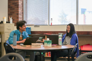 Students chatting while sitting at a table